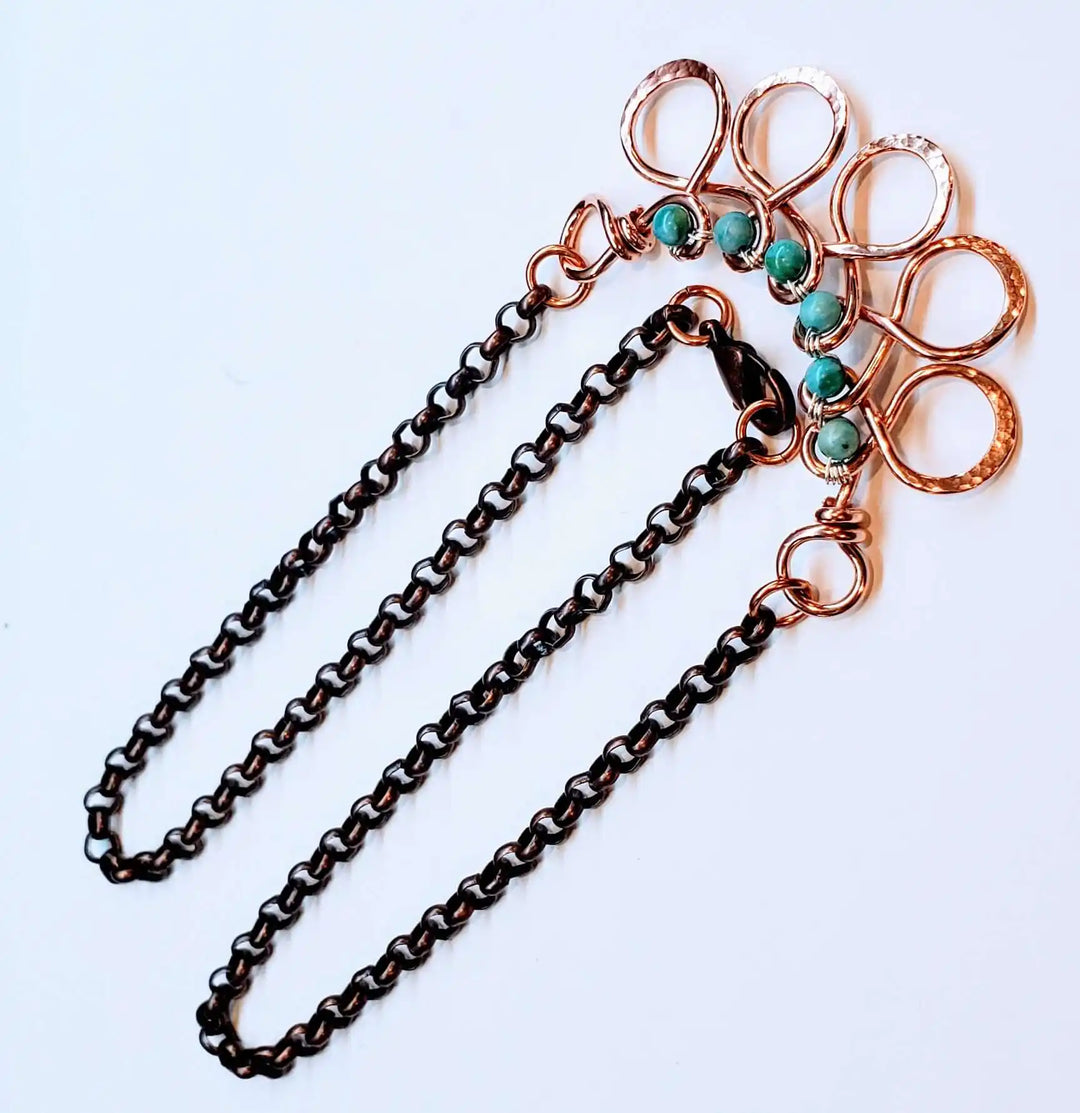 Seen on Ashley Liao Copper Turquoise Wire Wrapped Necklace featuring intricate design and turquoise accents.
