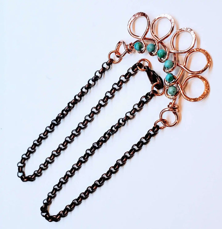 Seen on Ashley Liao Copper Turquoise Wire Wrapped Necklace featuring intricate design and turquoise accents.