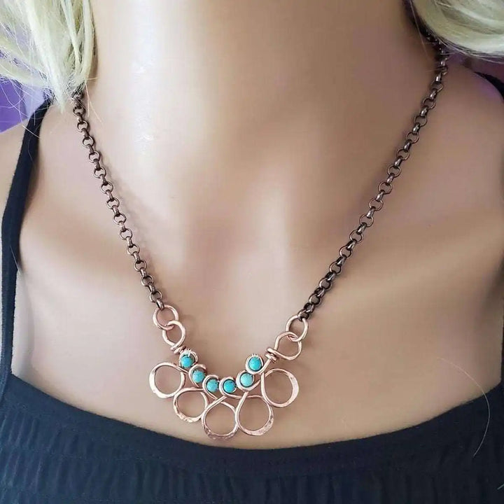 Seen on Ashley Liao Copper Turquoise Wire Wrapped Necklace displayed on a mannequin.