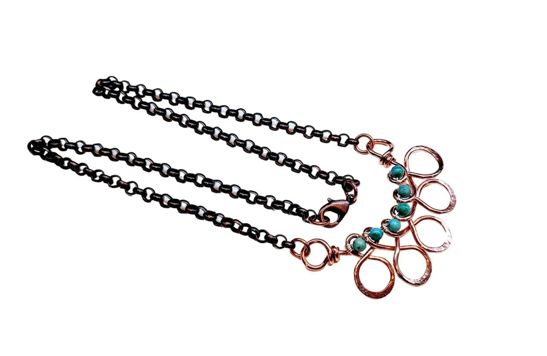 Seen on Ashley Liao Copper Turquoise Wire Wrapped Necklace with intricate design and stunning turquoise accents.