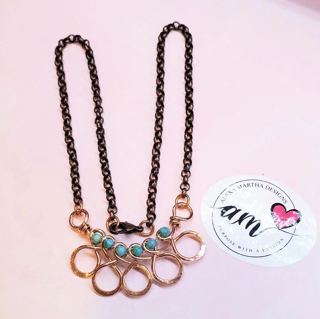 Seen on Ashley Liao Copper Turquoise Wire Wrapped Necklace with intricate design and vibrant stones.