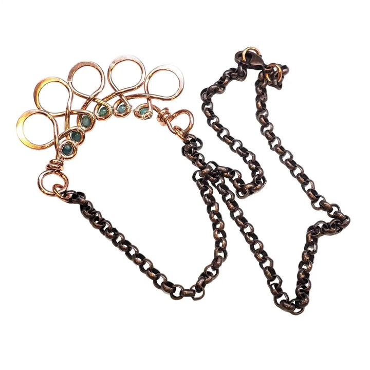 Seen on Ashley Liao Copper Turquoise Wire Wrapped Necklace with unique design and chain detail.