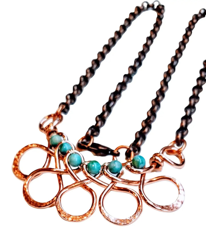 Seen on Ashley Liao Copper Turquoise Wire Wrapped Necklace with teal stones and a unique wire design.