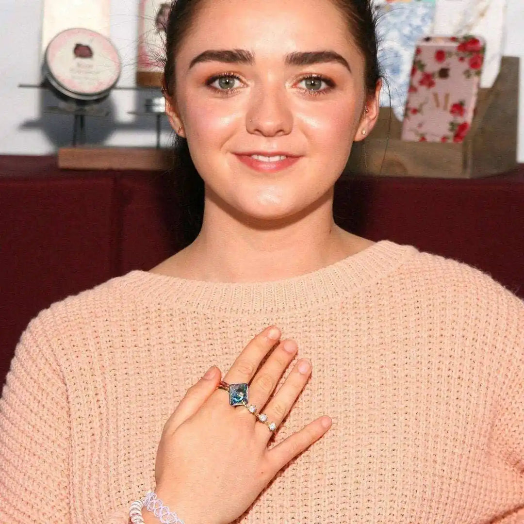 As Seen on Maisie William Super Sparkly Crystal Bling Ring worn by a smiling woman in a cozy sweater.