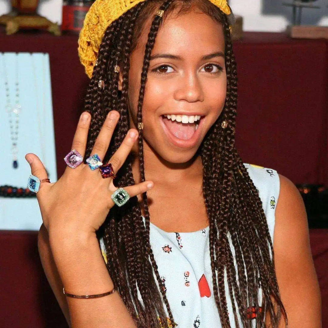 As Seen on Maisie William Super Sparkly Crystal Bling Ring worn by a girl with braided hair and colorful clothing.