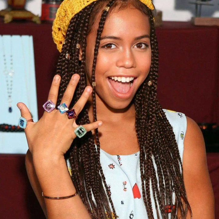 As Seen on Maisie William Super Sparkly Crystal Bling Ring worn by a girl with braided hair and colorful clothing.
