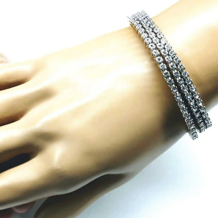 Catch-Free Crystal Rhinestone Tennis Bracelet Bangle displayed on a hand with clear rhinestones sparkling elegantly.