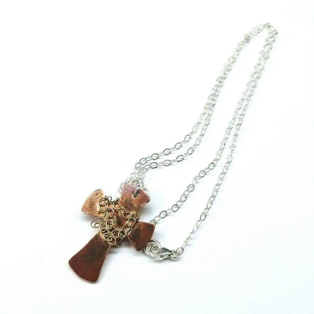 Chained Hammered Copper Cross Necklace For Him Or Her on a silver chain, featuring an artisan hammered design.