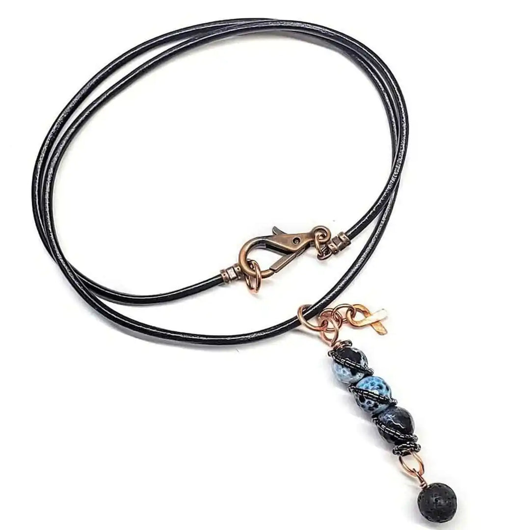 Child Abuse Awareness Agate Necklace With Lava Rock Bead featuring blue agate beads and copper accents.