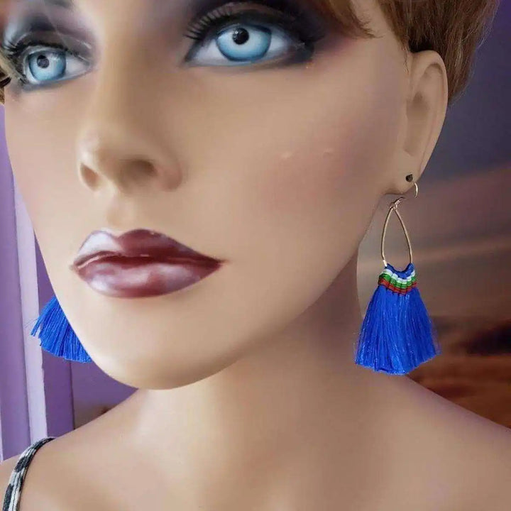 Handmade Hawaii Hula Skirt Rayon Silk Tassel Hoop Earrings displayed on a mannequin, featuring vibrant blue tassels.
