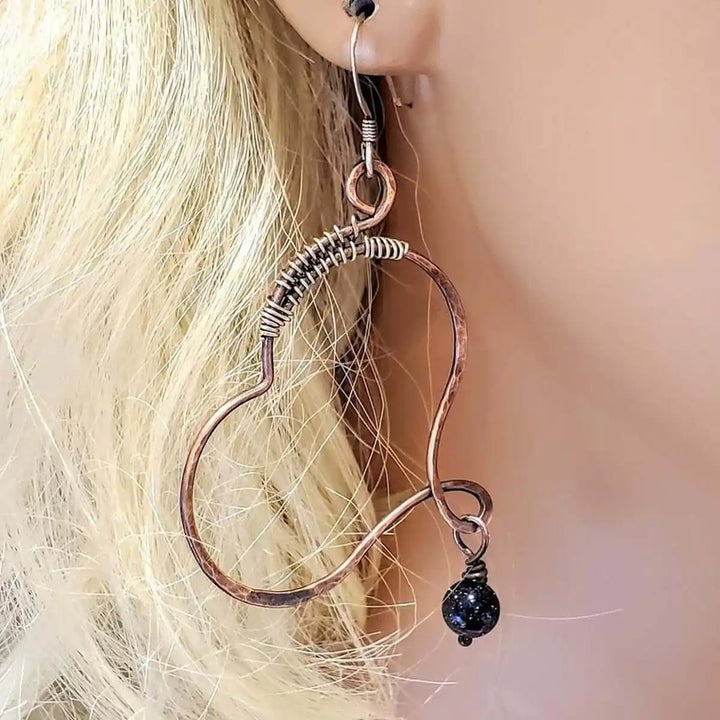 Sculpted Copper Butterfly Wing Abuse Survivor Earrings showcasing stunning copper hoops with black Swarovski crystal dangles.