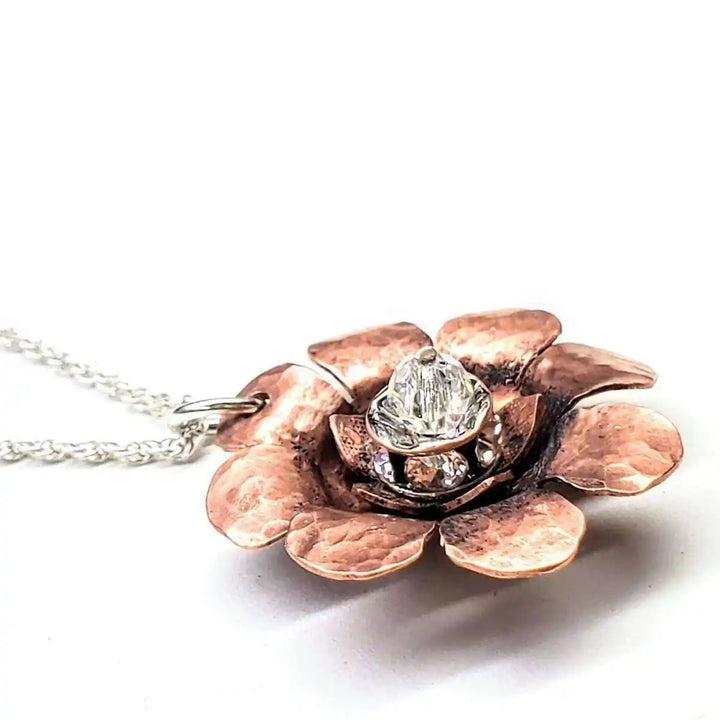 Copper Crystal Flower Blossom Fidget Spinner Necklace featuring a handmade copper flower design with crystal.