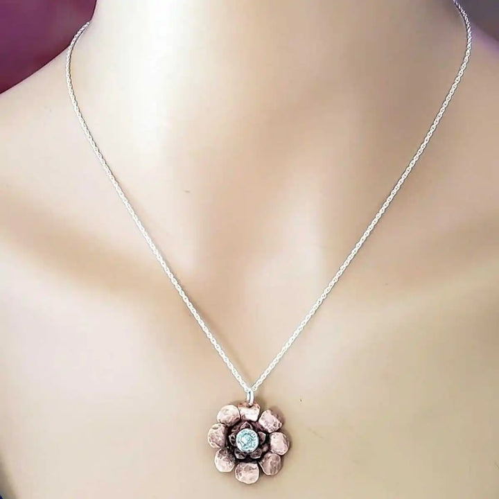 Copper Crystal Flower Blossom Fidget Spinner Necklace on display, featuring a detailed copper flower pendant.