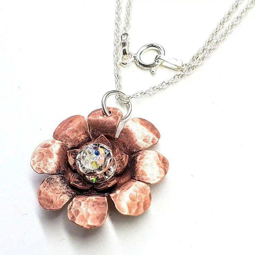 Copper Crystal Flower Blossom Fidget Spinner Necklace featuring a hammered copper flower and crystal centerpiece.