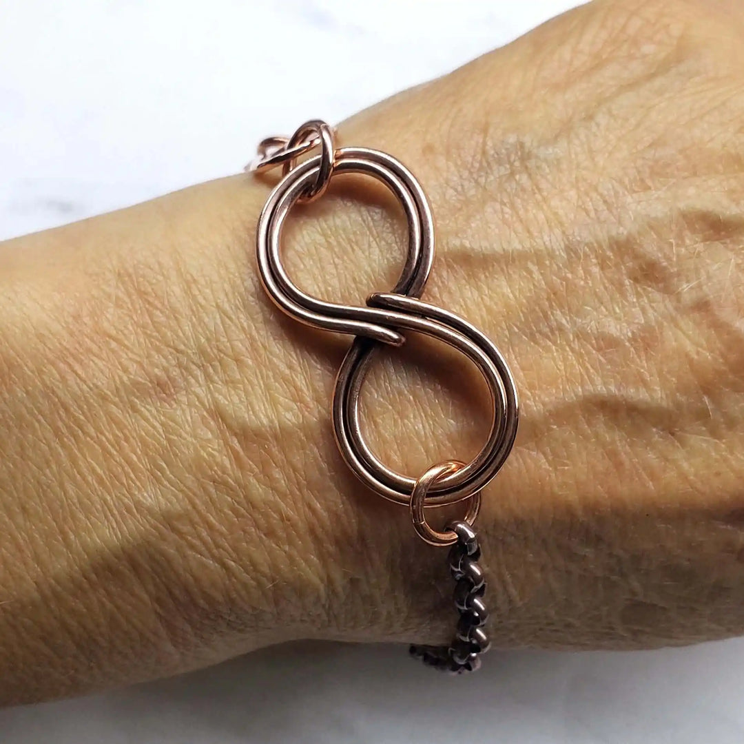 Wire Sculpted Copper Double Infinity Chain Bracelet worn on wrist, showcasing its intricate wire-wrapped design.