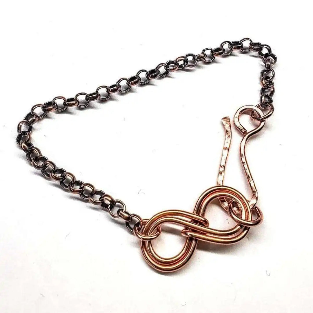 Wire Sculpted Copper Double Infinity Chain Bracelet showcasing intricate craftsmanship and a timeless infinity symbol.