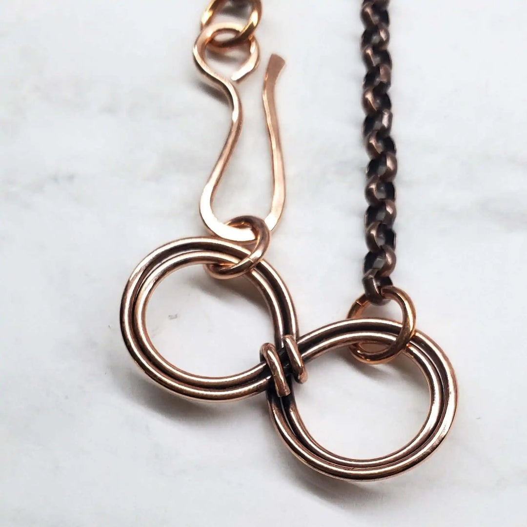 Close-up of Wire Sculpted Copper Double Infinity Chain Bracelet showcasing intricate double infinity design.
