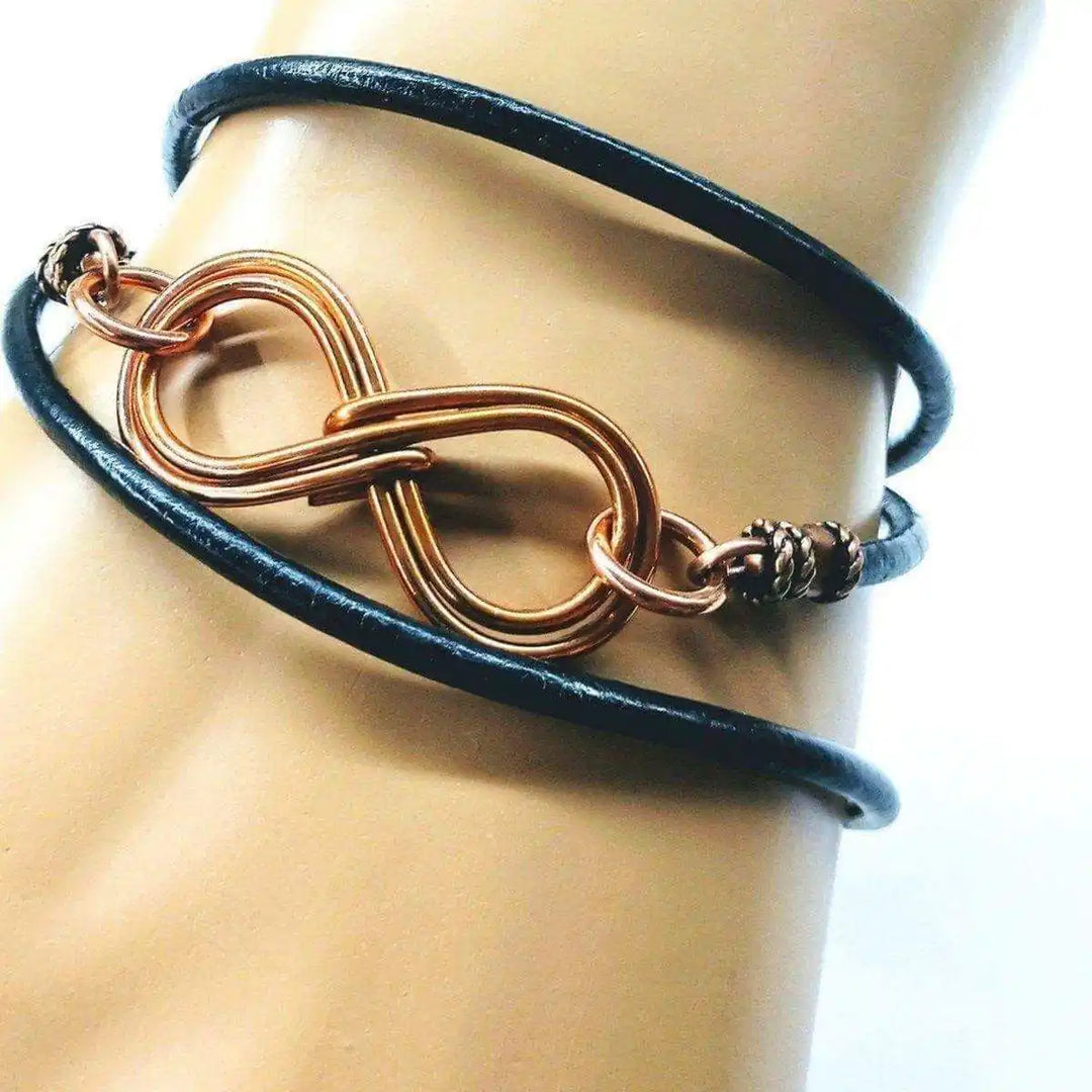 Copper Double Infinity Gender Neutral Leather Wrap Bracelet on display with hand-formed copper infinity symbols.