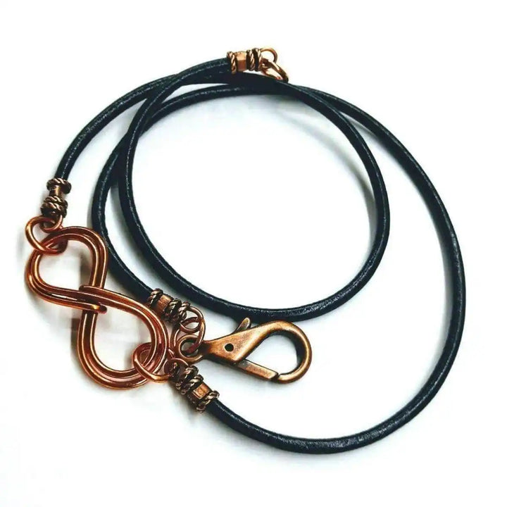 Copper Double Infinity Gender Neutral Leather Wrap Bracelet on black leather cord with clasp and intertwined infinity symbols.