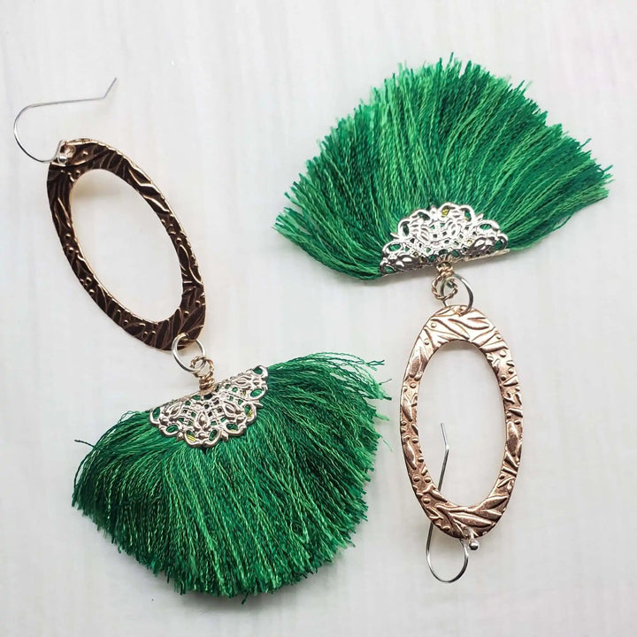 Rose Gold Filigree Silk Tassel Earrings Copper Embossed with green silk tassels and intricate oval metalwork.