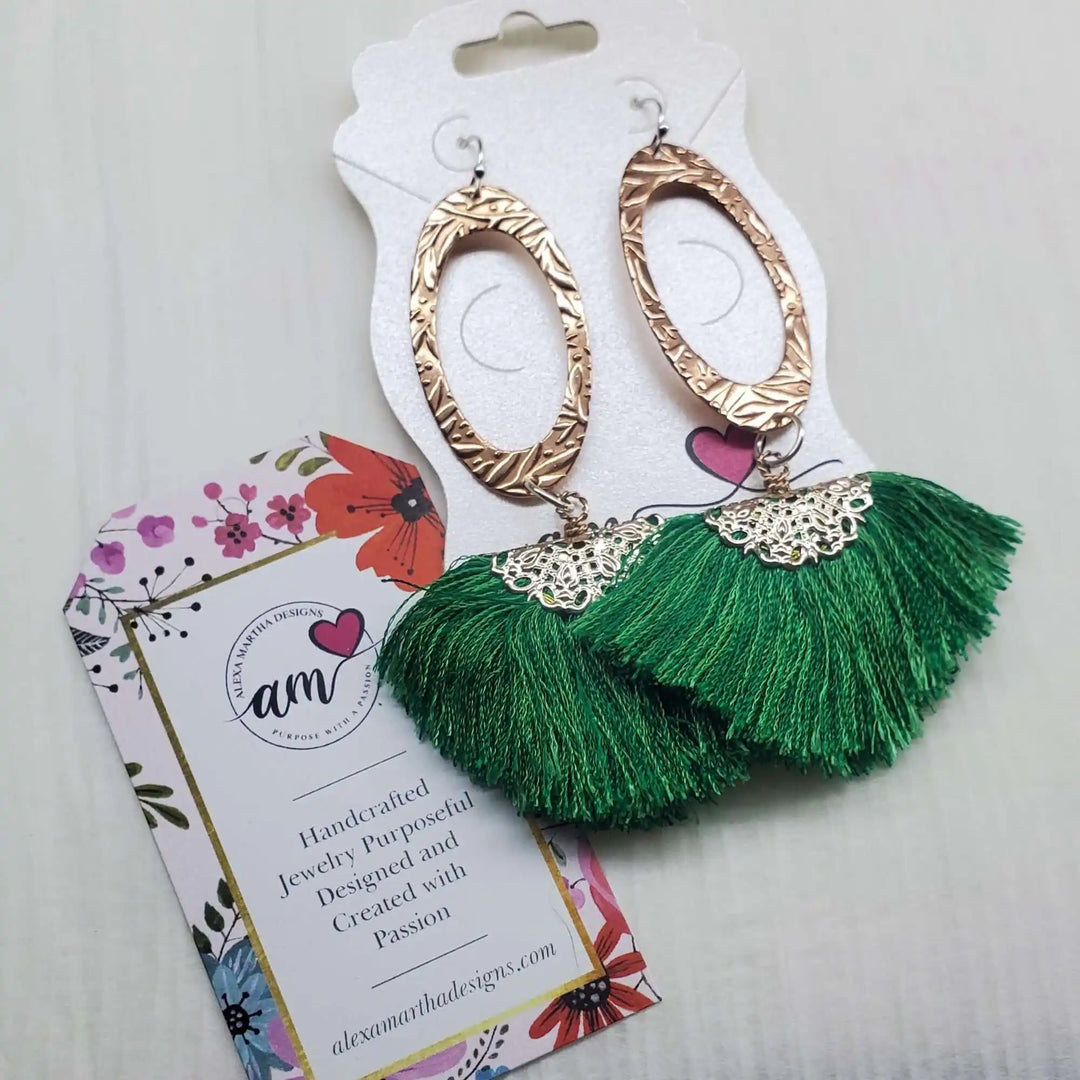 Rose Gold Filigree Silk Tassel Earrings Copper Embossed with green silk tassels and intricate metalwork.