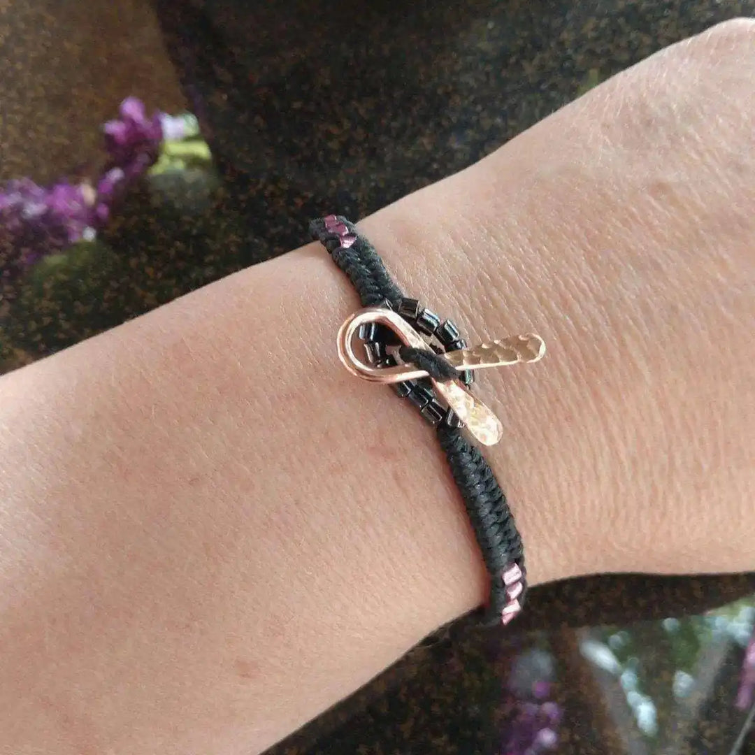 Copper Ribbon Black Pink Braided Breast Cancer Bracelet on wrist showcasing crafted design and details.