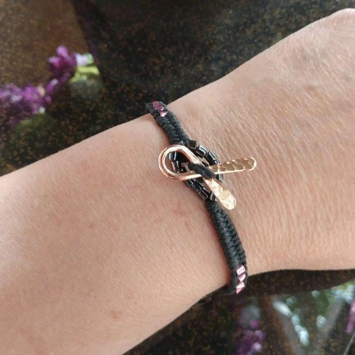Copper Ribbon Black Pink Braided Breast Cancer Bracelet on wrist showcasing crafted design and details.