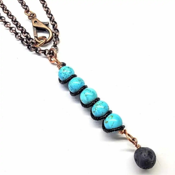 Copper Turquoise Pendant With Lava Rock Charm featuring turquoise beads and lava rock charm on a chain necklace.