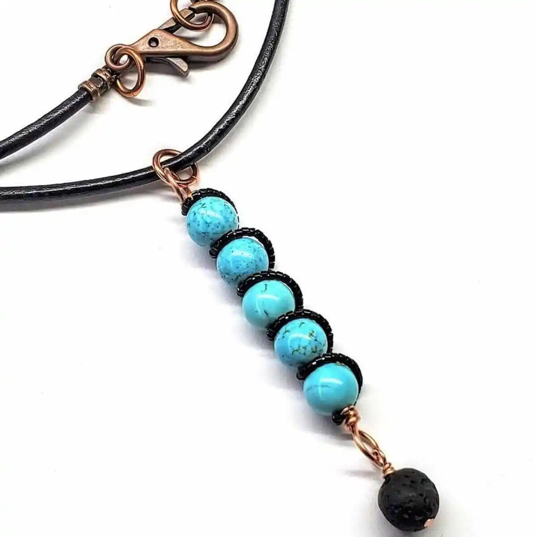 copper turquoise pendant with lava rock charm on leather cord, showcasing blue turquoise beads and lava rock charm