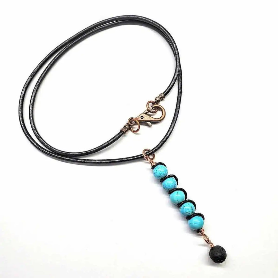 copper turquoise pendant with lava rock charm on a black cord necklace