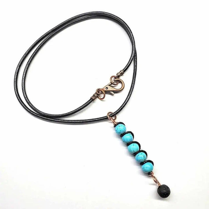 copper turquoise pendant with lava rock charm on a black cord necklace