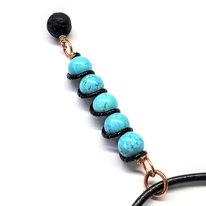 copper turquoise pendant with lava rock charm showcasing vibrant turquoise beads and a lava rock charm