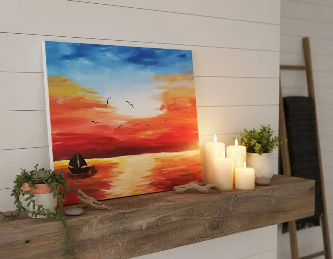 Acrylic Painting Sunset Over The Water Print Download displayed on a wooden shelf with candles and plants.