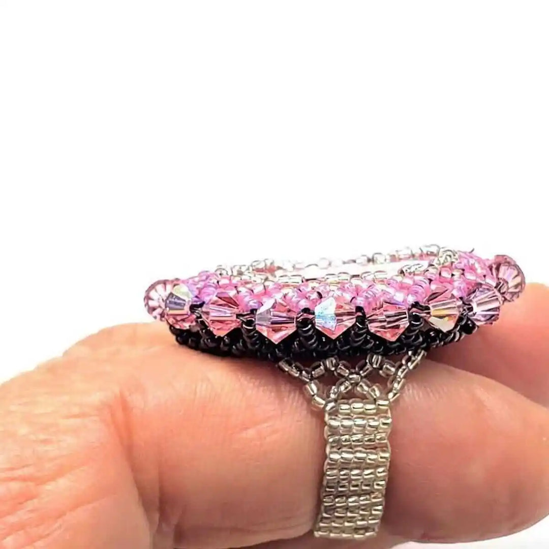 Epic Beaded Rose Crystal Bling Cocktail Ring on a hand showcasing its vibrant pink crystals and intricate beadwork design.