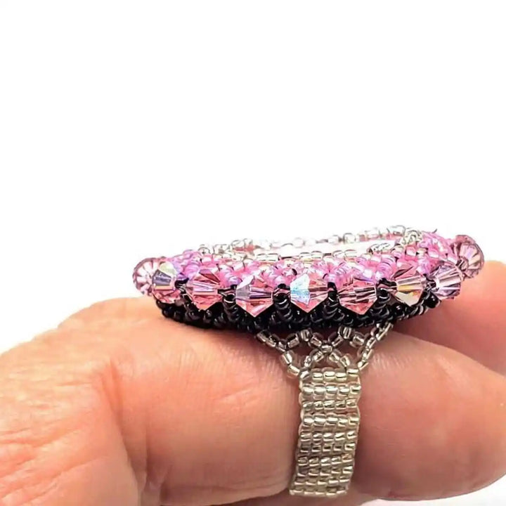 Epic Beaded Rose Crystal Bling Cocktail Ring on a hand showcasing its vibrant pink crystals and intricate beadwork design.