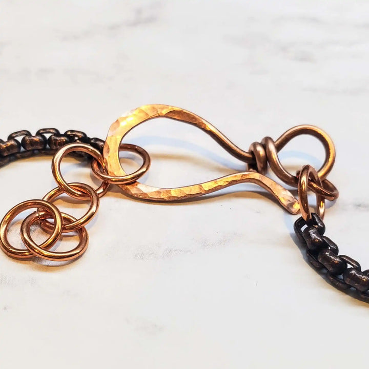 Close-up of the clasp detail on the Ergonomic Copper Sculpted Embossed Wire Gemstone Choker, showcasing intricate metalwork.