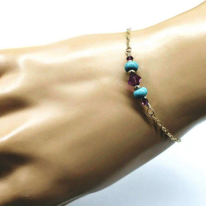 Handmade Gold Filled Pink Turquoise Gemstone Bracelet featuring turquoise and fuchsia crystals on a hand model.
