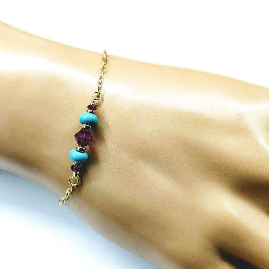 Handmade Gold Filled Pink Turquoise Gemstone Bracelet featuring pink fuchsia Swarovski crystals and turquoise gems on a hand.