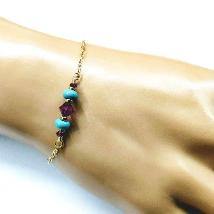 Handmade Gold Filled Pink Turquoise Gemstone Bracelet featuring pink fuchsia Swarovski crystals and turquoise gems on a hand.