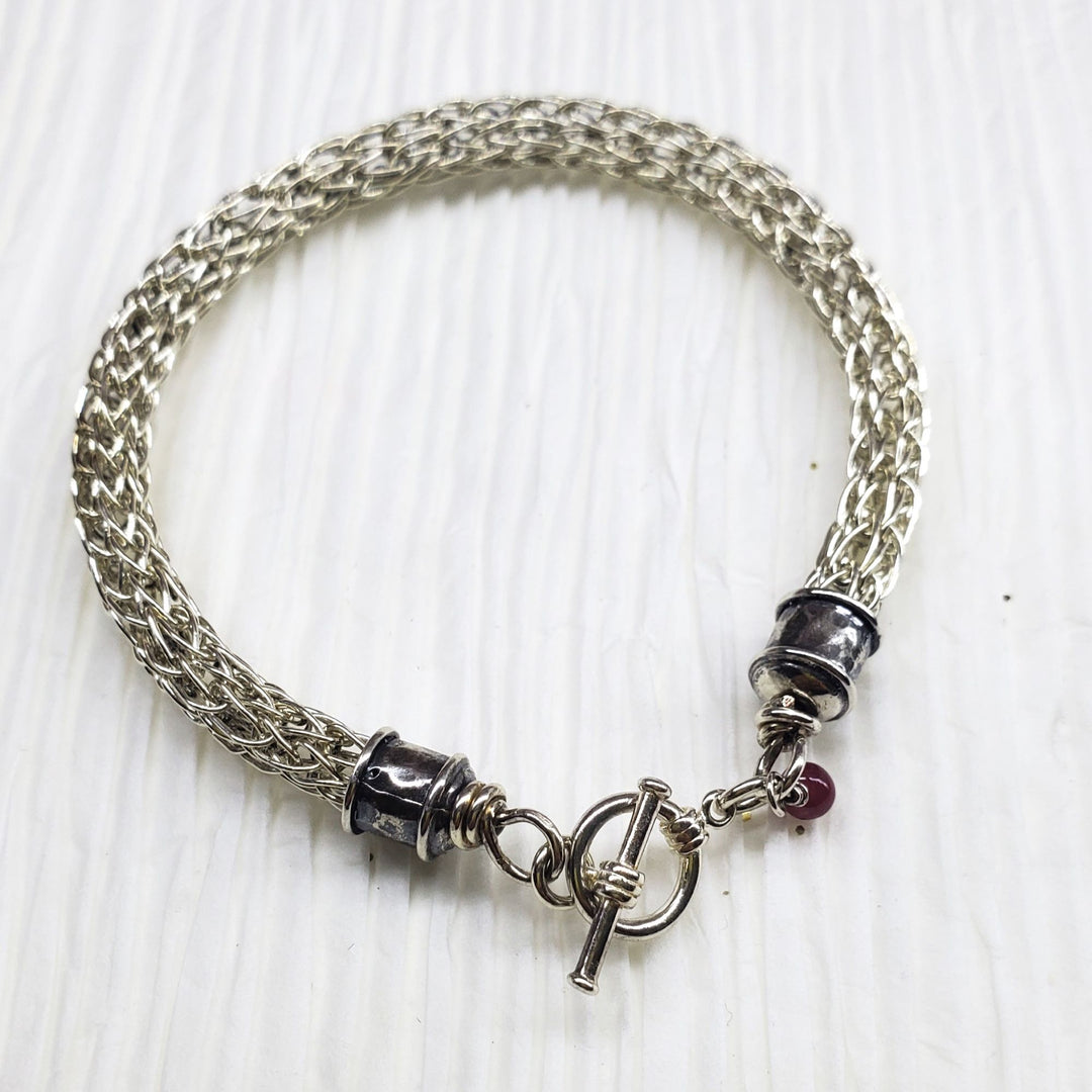 AMD1266Handmade 10mm Silver Viking Knit Bracelet with Ruby CharmJewelryBracelet$ 190.00Alexa Martha Designs