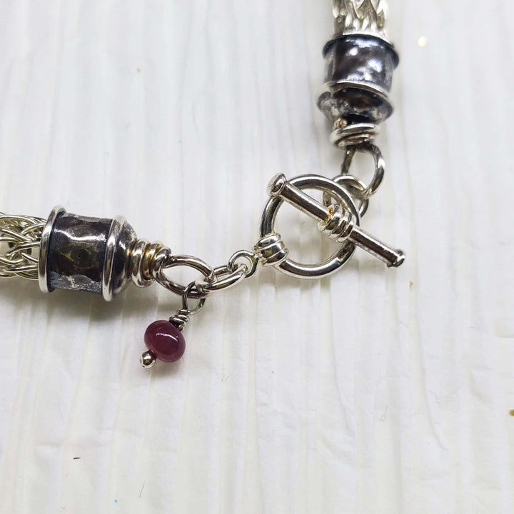 AMD1266Handmade 10mm Silver Viking Knit Bracelet with Ruby CharmJewelryBracelet$ 190.00Alexa Martha Designs