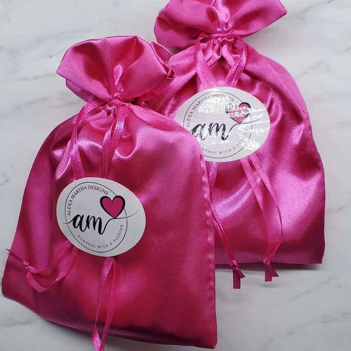 Pink satin gift bags with tags from AM Design, perfect for special occasions and beautiful packaging.