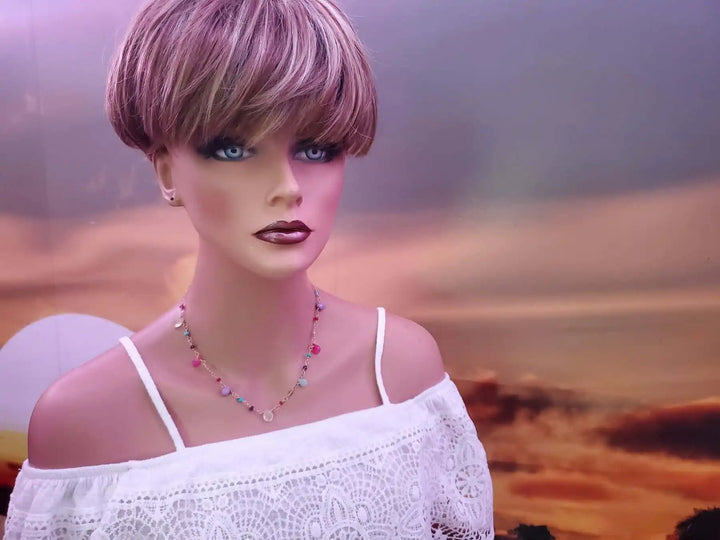 Adjustable Golden Wire Wrapped Kunterbunt Gemstone Necklace displayed on a mannequin against a scenic background.