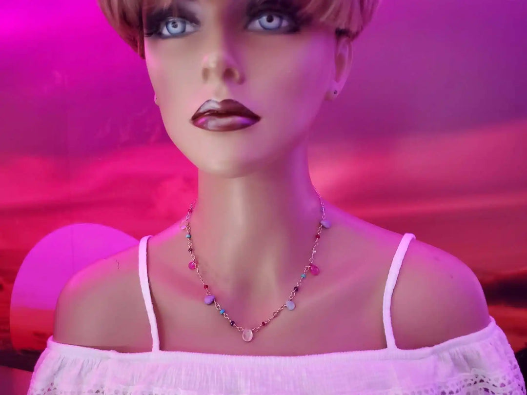 Adjustable Golden Wire Wrapped Kunterbunt Gemstone Necklace displayed on a mannequin against a vibrant sunset background.