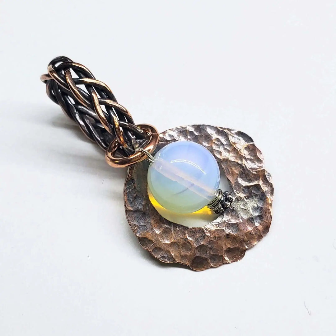 Handmade copper wire braided bail gemstone necklace featuring a rare Luminite gemstone on a textured copper base.