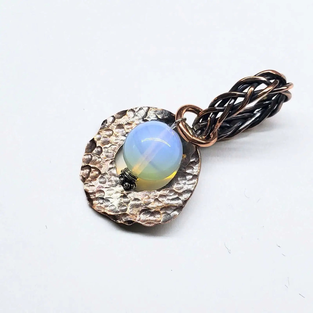 Handmade copper wire braided bail gemstone necklace featuring rare Luminite gemstone on a textured copper pendant.