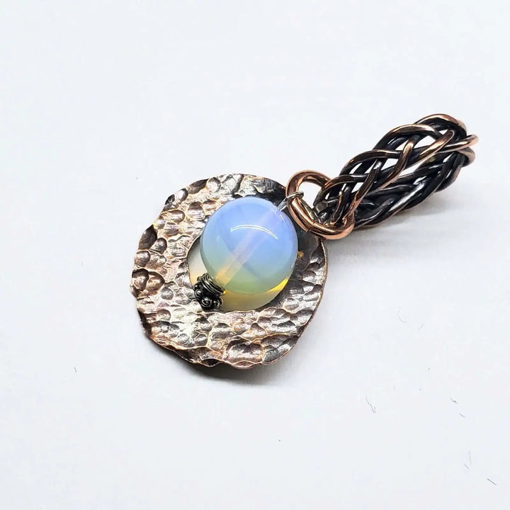 Handmade copper wire braided bail gemstone necklace featuring rare Luminite gemstone on a textured copper pendant.