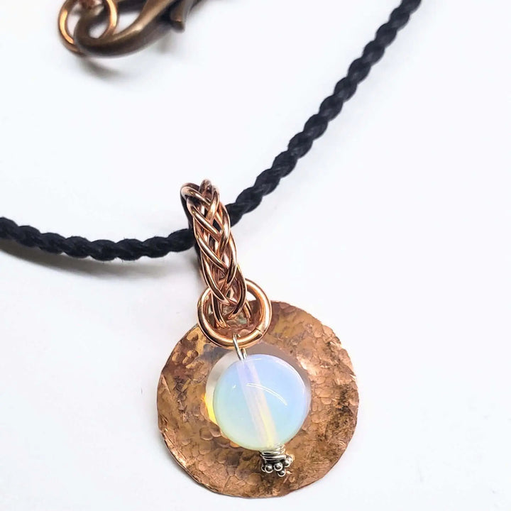 Handmade copper wire braided bail gemstone necklace featuring a rare Luminite gemstone on a braided cord.