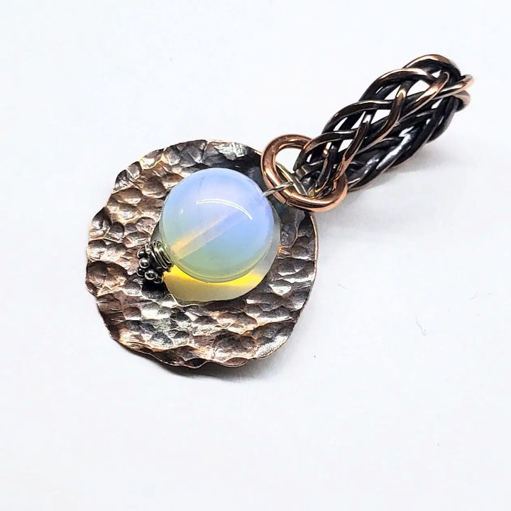 Handmade copper wire braided bail gemstone necklace featuring a rare Luminite gemstone on a textured metal pendant.