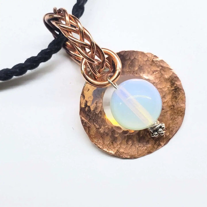 Handmade copper wire braided bail gemstone necklace featuring rare Luminite gemstone and textured copper pendant.